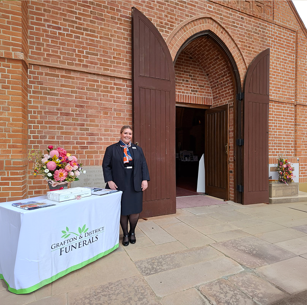 funeral director in front of the church