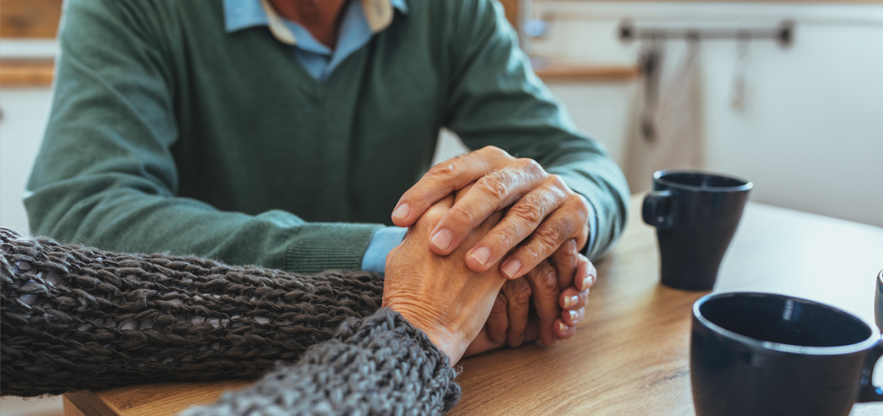 hands clasped in support and comfort