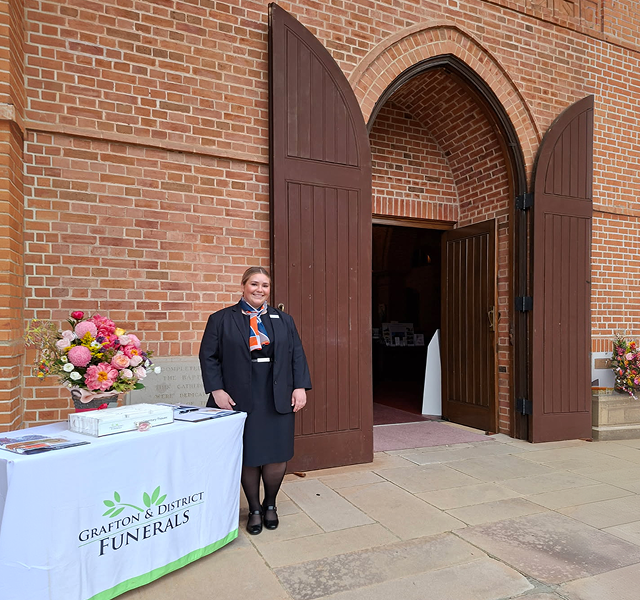 funeral director infront of the church