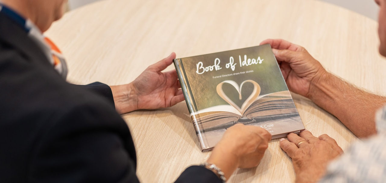 An image of an open book which has the middle pages arranged in a shape of a heart
